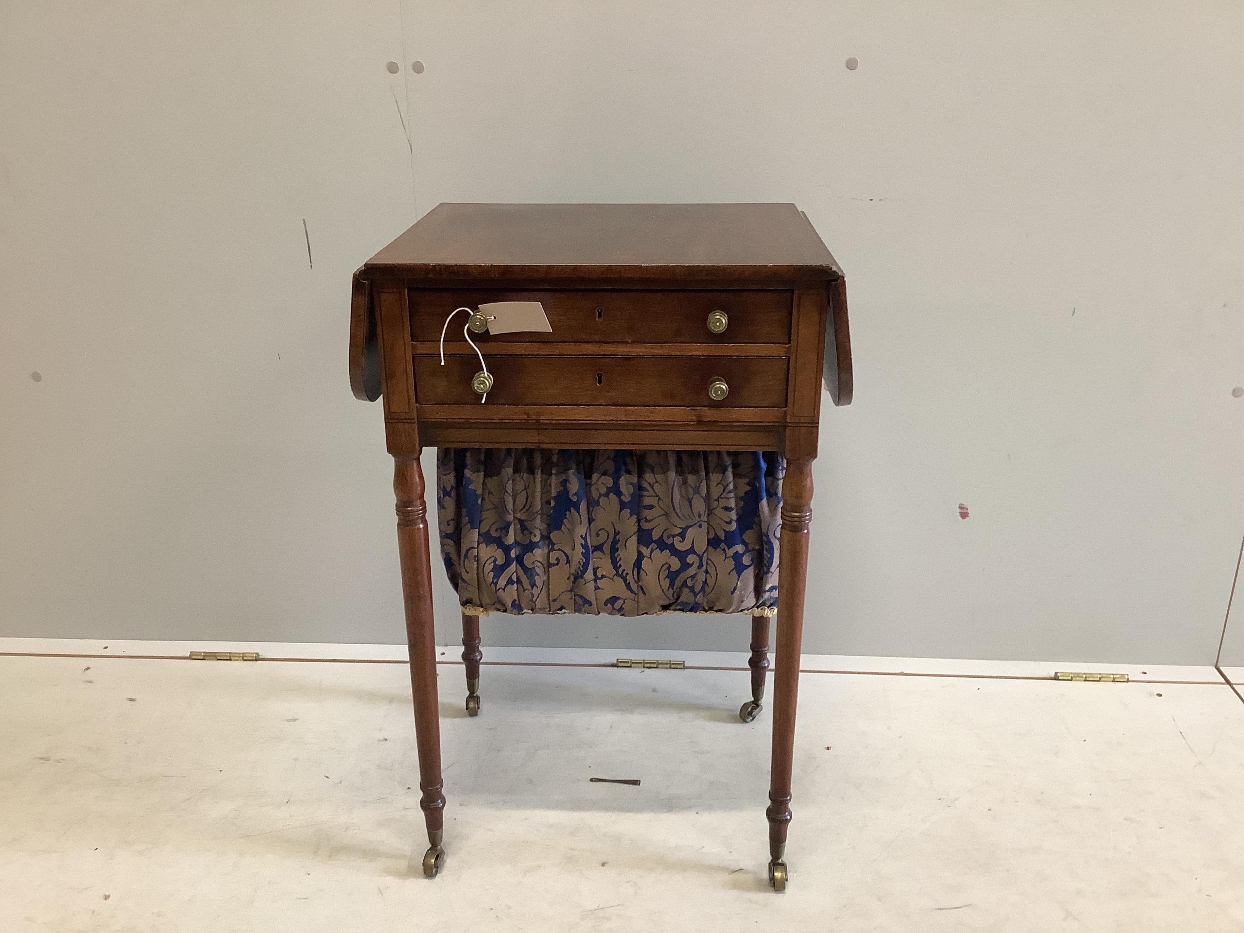 A late Georgian inlaid mahogany sewing table having twin flaps and two drawers on slender turned tapering legs on brass castors, width 47cm, depth 38cm, height 74cm. Condition - fair